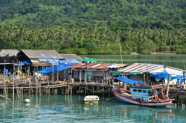 View landscape seascape and fishing boat ship floating in water sea waiting catch fish and marine life in ocean at fishing village house home on Koh Chang island at Gulf of Thailand in Trat, Thailand