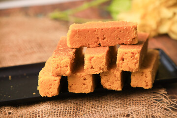 Mysorepak indian famous traditional sweet closeup with selective focus and blur
