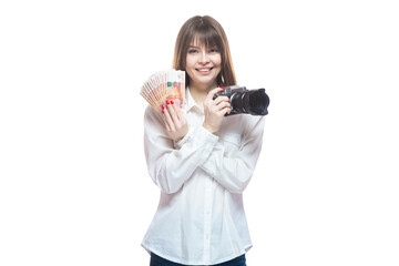 Portrait of a young woman in a white shirt holding a camera and Russian money rubles in her hand. The concept of a successful photographer in the Russian Federation, a wedding photographer, a photo