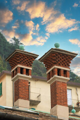 chimneys on the roof against the background of clouds
