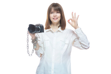Copyright. The camera is chained to the photographer's hand. The concept of protecting the photographer from theft of his photos. Isolated on white background.
