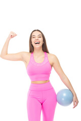 A beautiful, athletic, slim, smiling and cheerful woman in a pink tracksuit in a comic uniform demonstrates the muscles of the biceps of her arm, and holds a blue ball in her other hand. Lifestyle