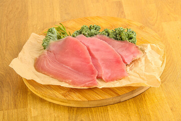 Raw salted tuna slice over board