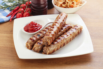 Grilled sausages with cabbage and sauce
