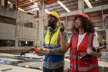 Industrial factory and manufacturing concept. Engineering with technician working with crane.