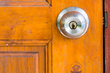 Fototapeta premium Door knob and keyhole on wooden door, close up image