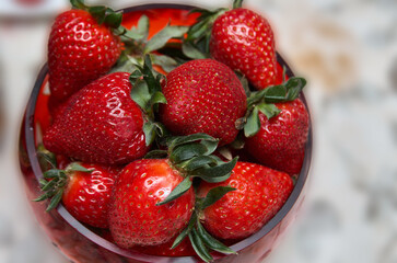 Closeup of round dish with fresh organic strawberries