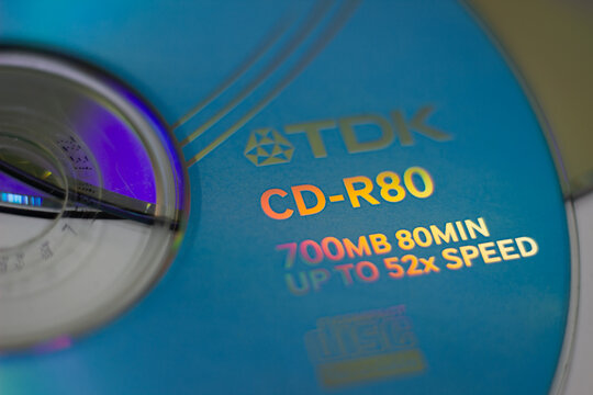 Sochi, Russia - April 22 2022: CD-R disks memory storage system. Old memory storages. TDK company brand name and logo on surface of CD recordable optical disk. 