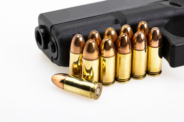 9 mm. gun bullets , Full metal jacket ammunition and automatic handgun on white background