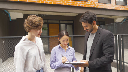 A happy couple sign an agreement contract signature for real estate to broker or agent for customer for buy or sell a new home or house. People