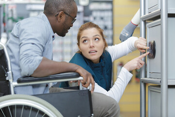 Fototapeta premium woman assisting man in wheelchair