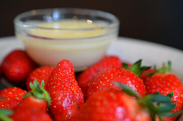 Ripe juicy strawberries with condensed milk