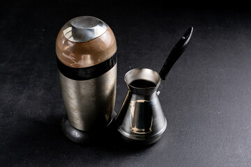 Coffee turk and grinder on dark background