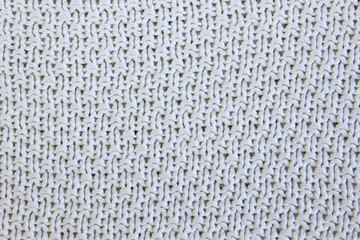 Soft light natural texture of knitted wool textile material background. White crochet cotton fabric woven canvas