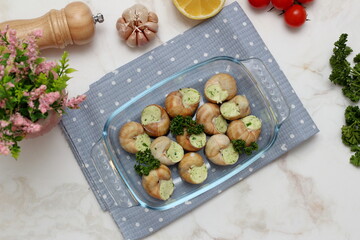 Stuffed snails with vegetables in a glass container