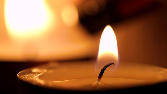 Lighting candles for esoteric ritual, macro shot close up detail view.