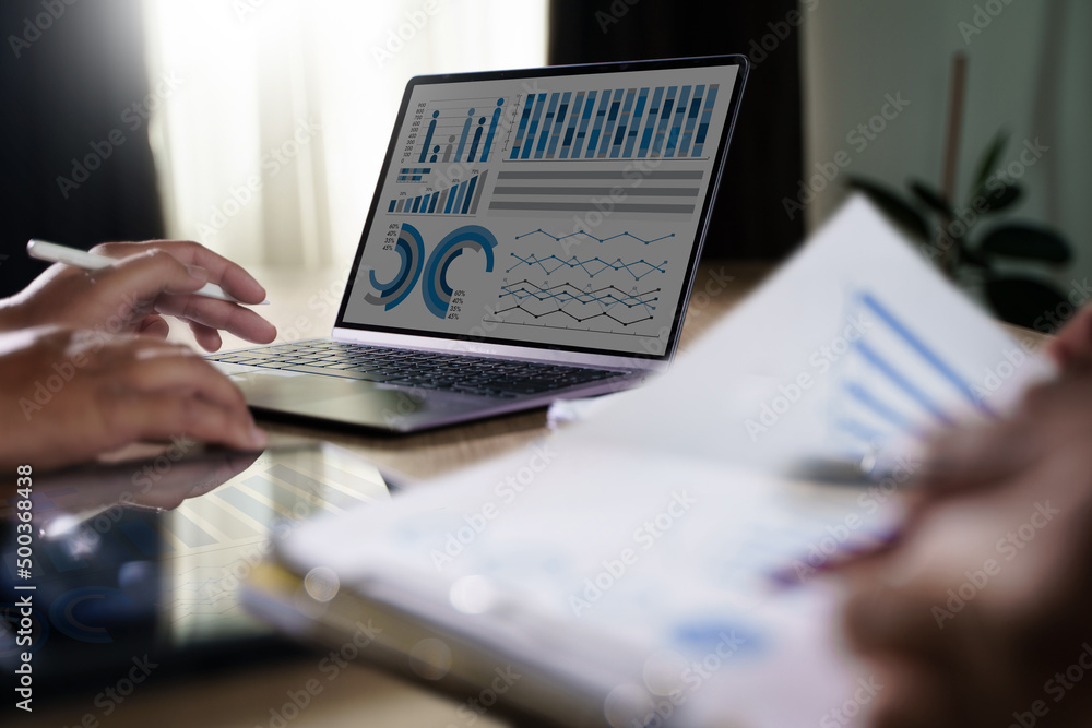 Poster businessman working on laptop computer on desk document researching financial results searching info