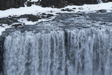 The Power and magic of powerful Iceland Dettifoss Waterfall Cascade in ice snow winter frozen...