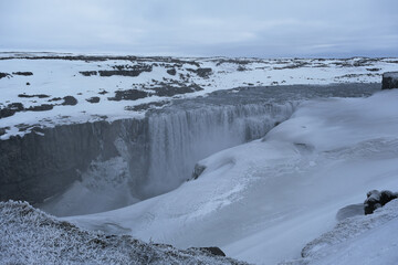 The Power and magic of powerful Iceland Dettifoss Waterfall Cascade in ice snow winter frozen...