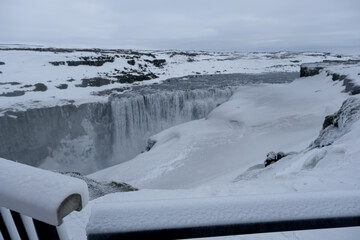 The Power and magic of powerful Iceland Dettifoss Waterfall Cascade in ice snow winter frozen...