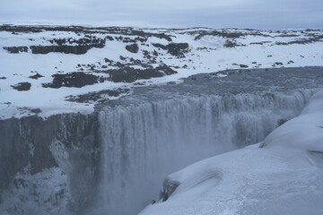 The Power and magic of powerful Iceland Dettifoss Waterfall Cascade in ice snow winter frozen...
