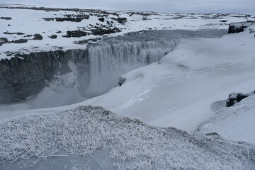 The Power and magic of powerful Iceland Dettifoss Waterfall Cascade in ice snow winter frozen...