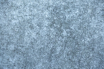 Blue background of decorative plaster with abstract spots. Unusual texture of this wall with beautiful patterns, creative surface background. Finishing coating for building cladding.