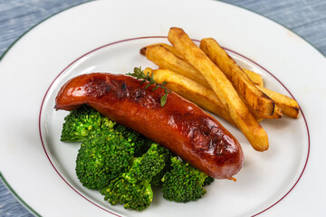 Sausage from Montb liard - French Charcuterie broccoli and fries