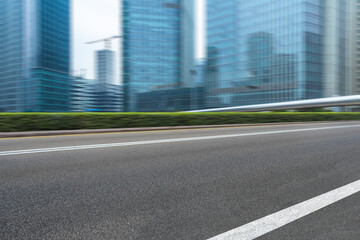 Obraz premium city empty traffic road with cityscape in background.