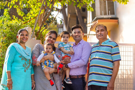 Group of happy multi-generation family smiling and standing together