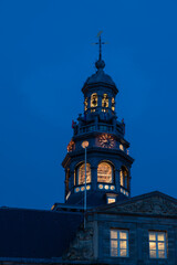 The impressive town hall Maastricht of 1684 located in the center of the market square during twilight. The bells of the carillon can be seen as well as the wooden construction of the tower