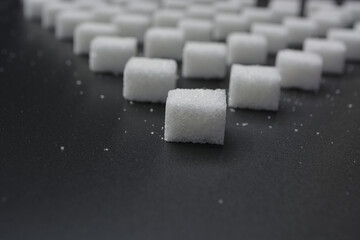 Sugar cubes pattern on shiny grey background. Abstract, minimal style.
