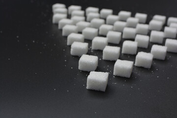 Sugar cubes pattern on shiny grey background. Abstract, minimal style.