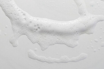 texture of soap foam on glass plate