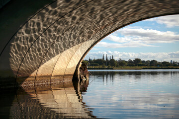 Reflection of Water Under Arched Cement Bridge