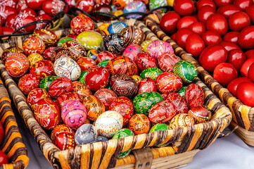 ornamental wooden eggs in the wicker basket