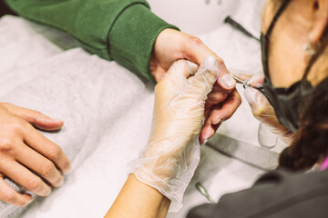 Women's hands in the manicure process close-up