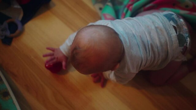 Baby Boy Playing With Toy On Floor At Home - Fairbanks, Alaska