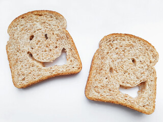 Two isolated funny slices of bread with eyes and mouth. Funnyl bread.