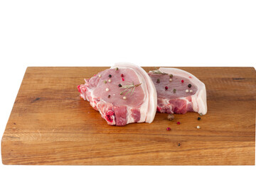 Fresh raw pork steaks on cutting board