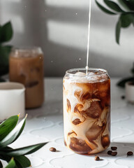 Ice coffee with milk stains on white backgrond . Pouring process. Menu, cold coffee recipe.