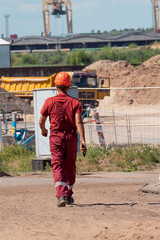builders work on a bridge construction site on a sunny day. construction machinery and timber formwork
