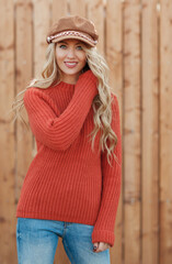 Young beautiful blonde woman with long hair in a cap