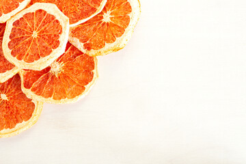 Dried citrus slices on white table with copy space