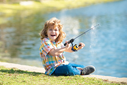 Funny happy little kid fishing on weekend. A fisherman boy stands