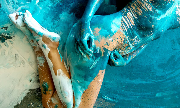 expressive sexy body part, hands and feet of a young woman, painted in turquoise, blue color, in the studio, modern abstract bodypainting