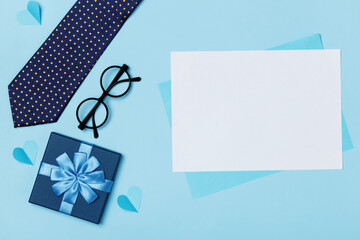 Father's day concept on blue background. Empty sheet of paper with space for text and copy space
