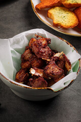 Closeup on bowl of chopped lamb ribs appetizer