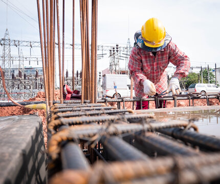 Construction workers fabricating steel reinforcement bar at the construction site. 