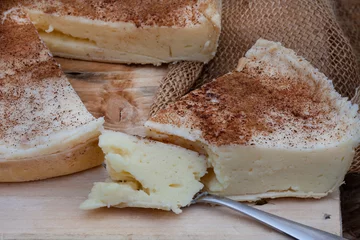 Deurstickers baked milk tart. a baked version of traditional South African milk tart or melktert, with cinnamon and rustic table © Aninka